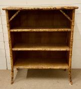 A bamboo and wicker open bookcase (H97cm W82cm D30cm)