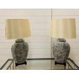 A pair of contemporary table lamps on a wooden base