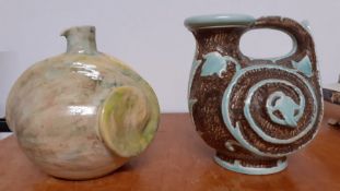 A pair of pottery vases and a charger by Gorbon Isil (signed: Mural?), a Burleigh Ware and another