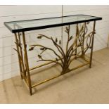 A gilt metal console table with glass top and tree design to centre (H80cm W120cm D40cm)