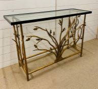A gilt metal console table with glass top and tree design to centre (H80cm W120cm D40cm)