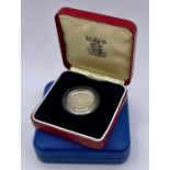 A Silver proof Royal Mint £1 coin and a Silver proof 1977 Jubilee crown.