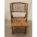 A bamboo and cane folding chair