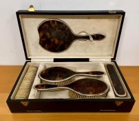 A silver and tortoise shell hallmarked dressing table set