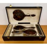 A silver and tortoise shell hallmarked dressing table set