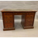 A pedestal desk with green leather top (H76cm W126cm D60cm)