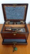 An antique travel writing wood and silk desk box, with key, (17x30.5x22.5 cm).
