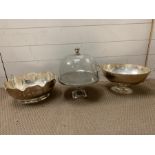 Two white metal serving dishes and cheese dome