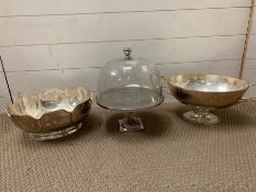 Two white metal serving dishes and cheese dome