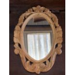 A small carved wooden framed mirror (46cm x 30cm)