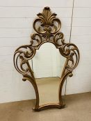 A continental style giltwood/composition wall mirror with scrolls to top and sides H153cm x W94cm
