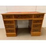 A pedestal desk with oxblood red leather top AF