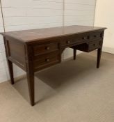 A mahogany knee hole desk with drawers to side and centre