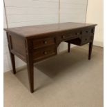 A mahogany knee hole desk with drawers to side and centre