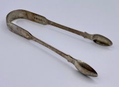 A pair of Georgian silver sugar tongs, hallmarked for 1822, makers mark JB