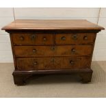 A walnut chest of two over two drawers on a bracket feet base (H72cm W98cm D54cm)