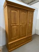 A pine triple wardrobe with drawers under (H203cm W164cm D55cm)