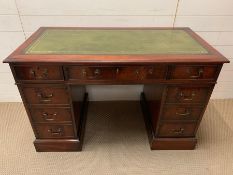 A reproduction mahogany pedestal desk by Charles Barr with rectangular leather insert and an