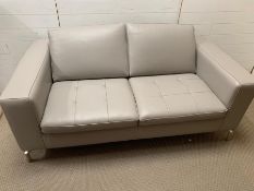 A two seater Natuzzi grey leather upholstered sofa (H77cm W172cm D93cm SH43cm)