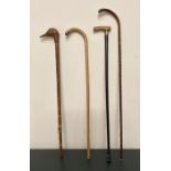 A Selection of four walking sticks, three with silver mounts and one with a carved Ducks Head top.