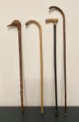 A Selection of four walking sticks, three with silver mounts and one with a carved Ducks Head top.