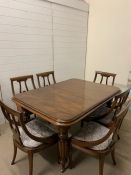 A six seater dining table with two extension leaves on reeded legs (H76cm W150cm D109cm extensions