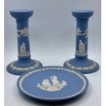 A group of vintage wedgwood ‘light blue’ jasper ware comprising of a pair of candlesticks and a