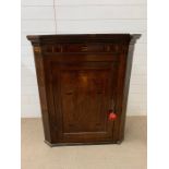 A George III North Midland oak hanging corner cupboard (H110cm W88cm D52cm)