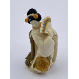 Signed Netsuke of a woman holding a fan, signed