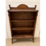 An oak open bookcase with beading design to top (H120cm W73cm D25cm)