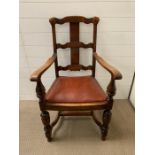 An oak open armchair with oxblood seat cushion