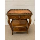 A parquetry three tier serving table with gilt bronze mounts on cabriole legs