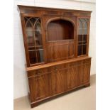 A mahogany display unit with drop down drinks cabinet and four panel cabinets below