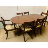 A mahogany dining table with string inlaid to edge and side chairs with carved twisted splat