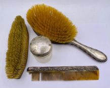 A selection of silver items to included lidded pot, brushes and comb