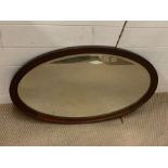 An oval mahogany wall mirror (82cm x 52cm)