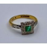 An 18ct gold and platinum emerald and diamond ring Size K