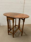 A small drop side occasional table (H74cm W90cm)