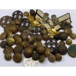 A selection of military insignia, cap badges, buttons etc.