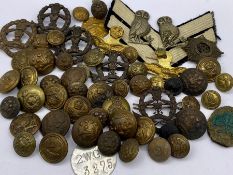 A selection of military insignia, cap badges, buttons etc.