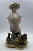 A Lladro figure of a person selling pottery