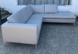 A corner sofa with grey leather upholstery by Natuzzi (see photo for measurements)