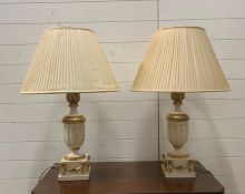 A pair of white and gilt table lamps with swags and foliage