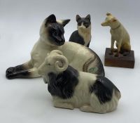 A vintage Siamese cat by Beswick and three more porcelain pets, (12x19 cm cat). (4)