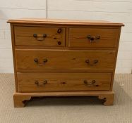 A pine chest of drawers on bracket feet, two short over two long (H76cm W90cm D48cm)