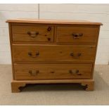 A pine chest of drawers on bracket feet, two short over two long (H76cm W90cm D48cm)