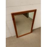 A pine wall mirror (77cm x 51cm)