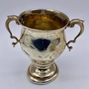 A silver two handled cup, indistinct hallmarks total weight 77g