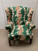 An 18th century wing back chair with mahogany frame