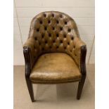 A button back leather club chair
